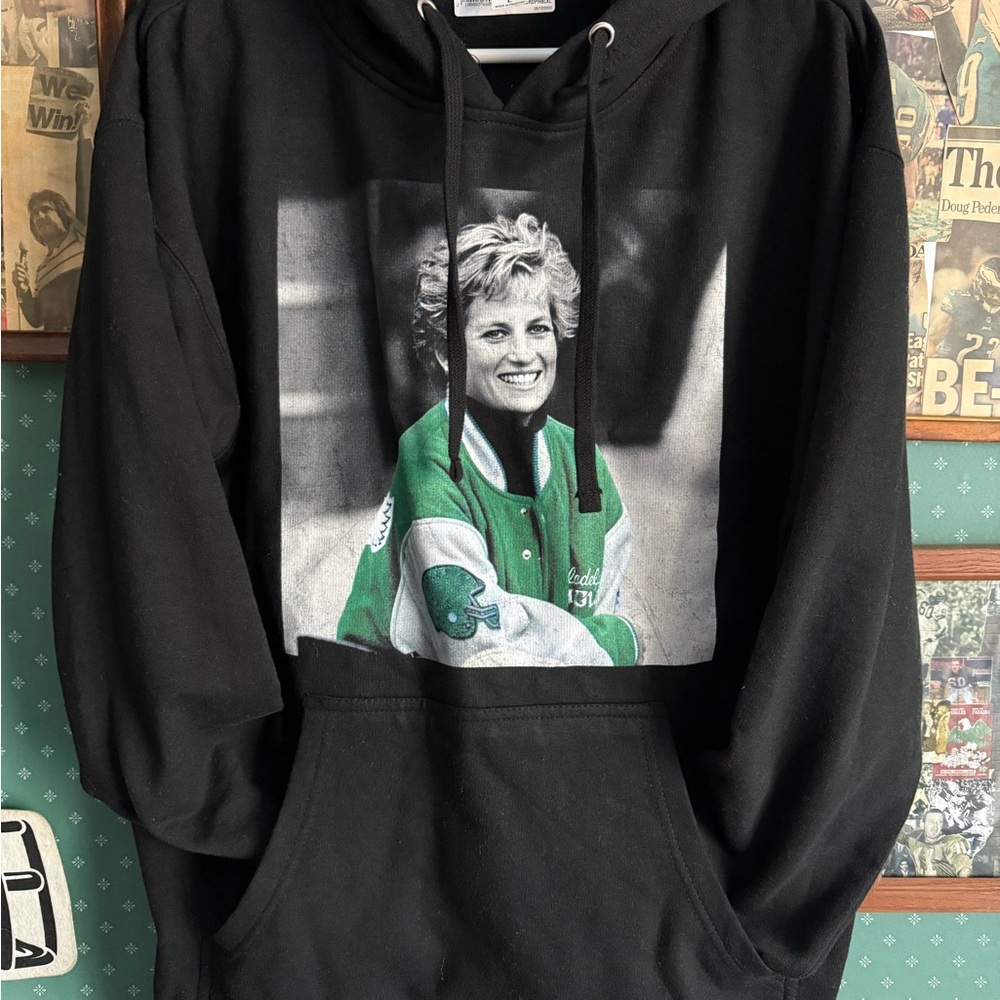 Iconic Princess Diana hoodie, wearing Eagles varsity jacket
